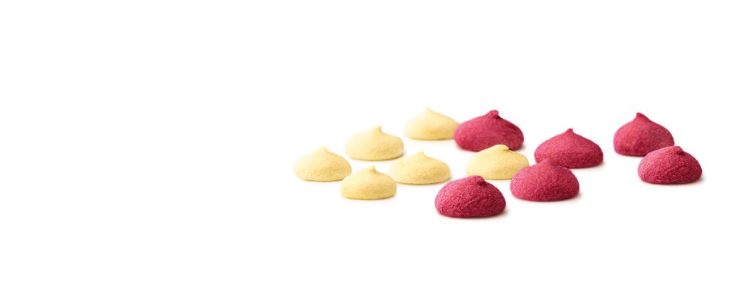 An assortment of red and white smoothie drops.