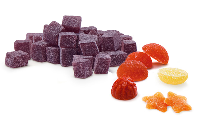 Tasty-looking fruit granules, shapes and juice drops in various shades of orange and purple.