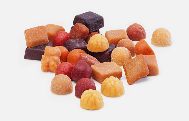 A mix of vitamin fruit gums in various shapes and colors.