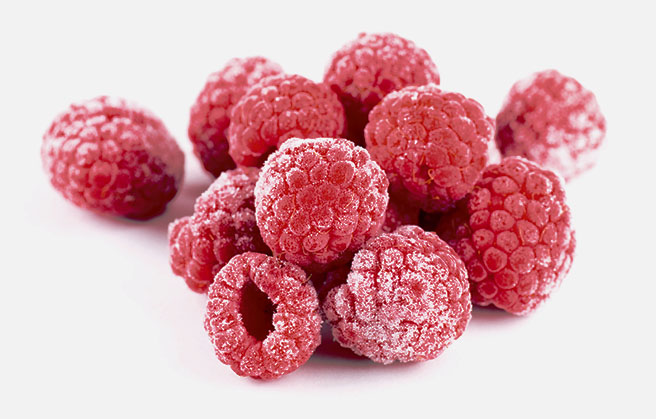 A bunch of frozen raspberries up close.