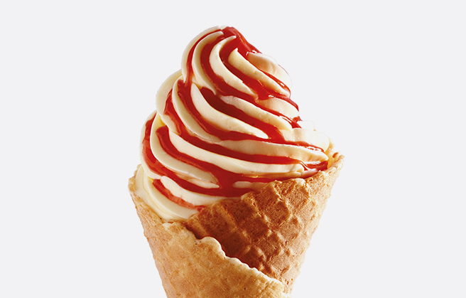 Ice cream with creamy fruit paste in a cone